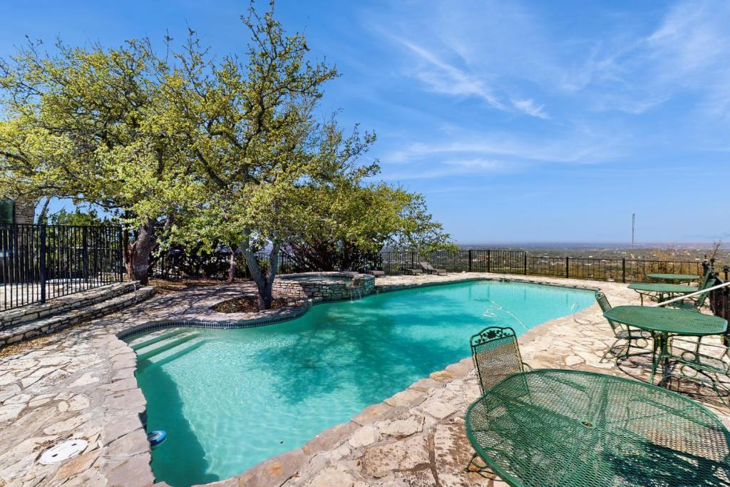 a swimming pool with a table and a table and a table and a tablektop at Maverick Mountaintop Retreat in Canyon Lake