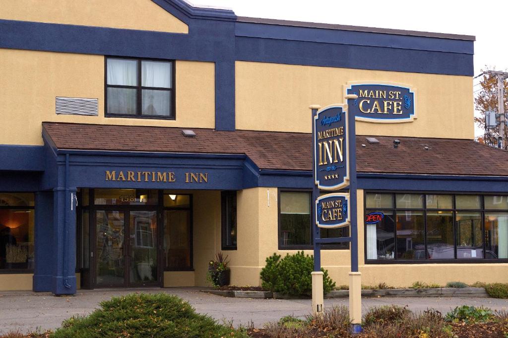 a building with a sign in front of a market cafe at Maritime Inn Antigonish in Antigonish