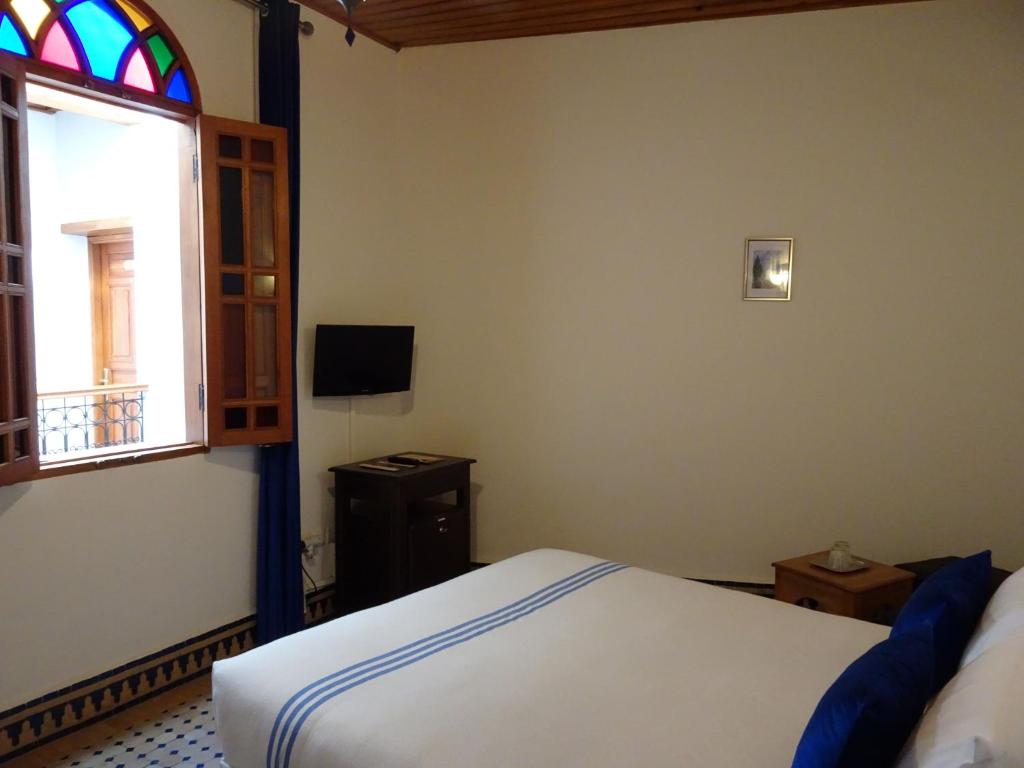 Postel nebo postele na pokoji v ubytování Riad Sabah