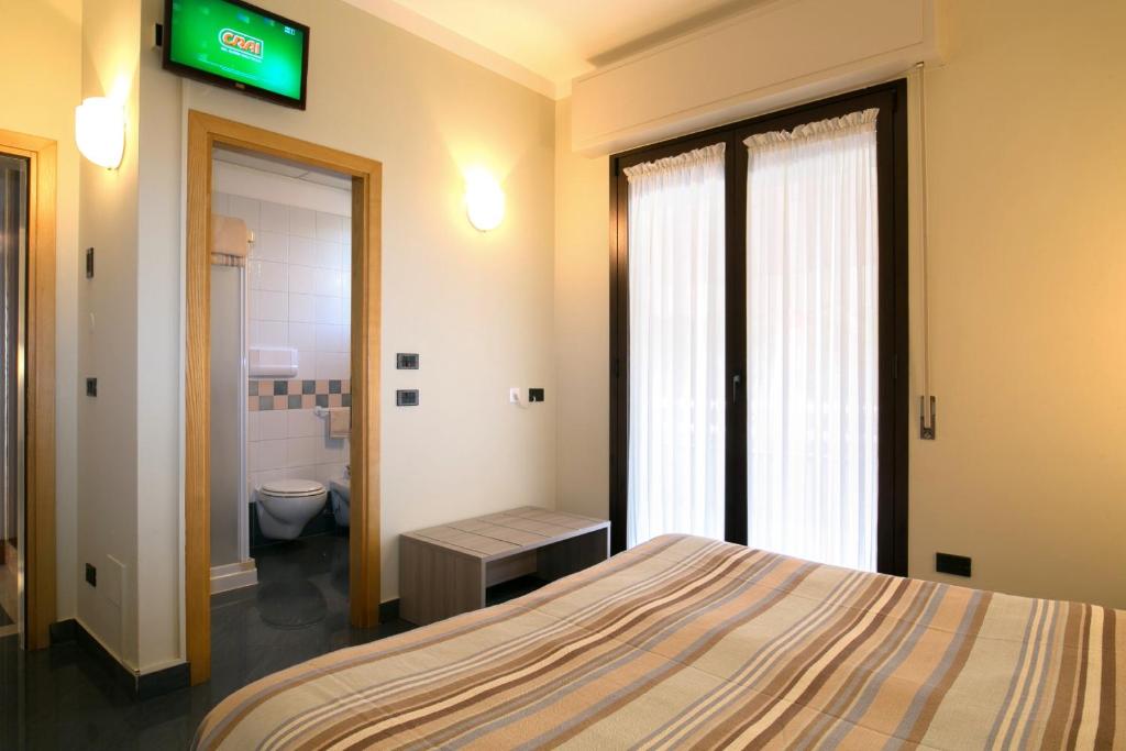 Postel nebo postele na pokoji v ubytování Hotel Olimpia