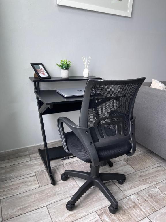 a black desk with a chair and a laptop at Ushaka Ocean Escape - Shaka Shores 5E in Durban