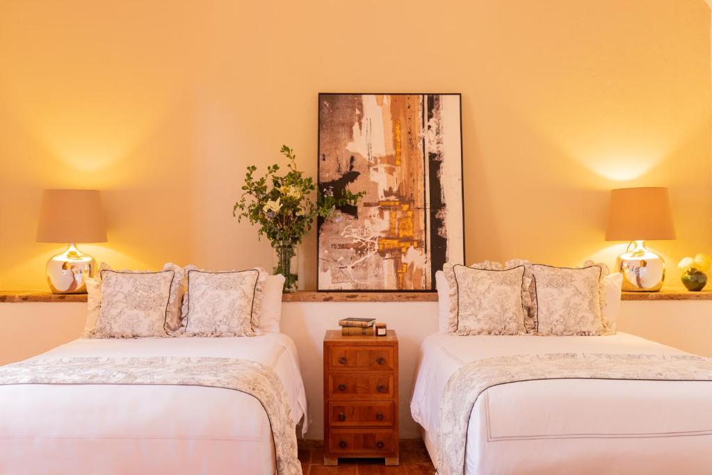 Postel nebo postele na pokoji v ubytování Hotel Casa De Quino