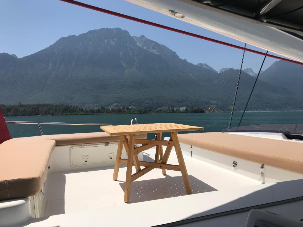 a wooden table on the deck of a boat at Floatinn Boat-BnB in Geneva