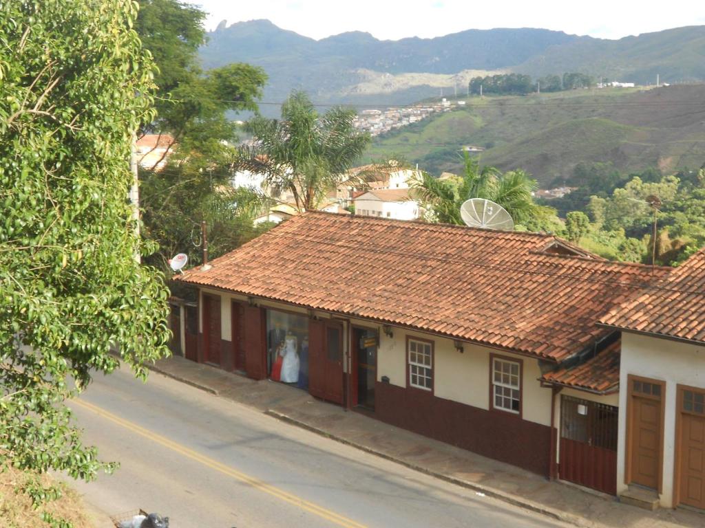 a street in a village with houses and hills at Pousada Simone in Ouro Preto