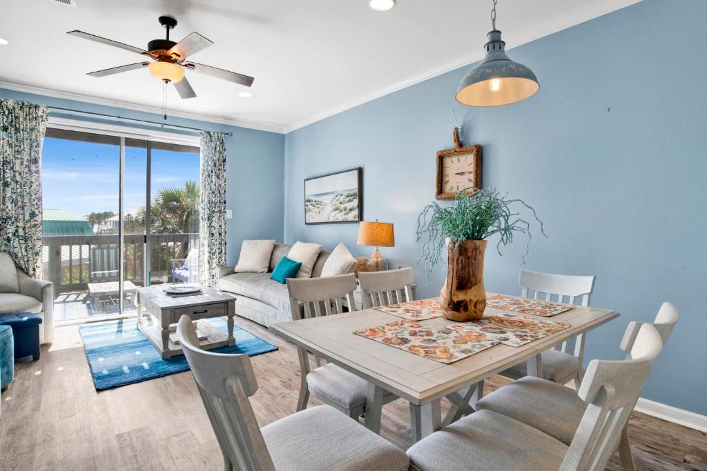 a dining room and living room with a table and chairs at TB Beach House in Dauphin Island