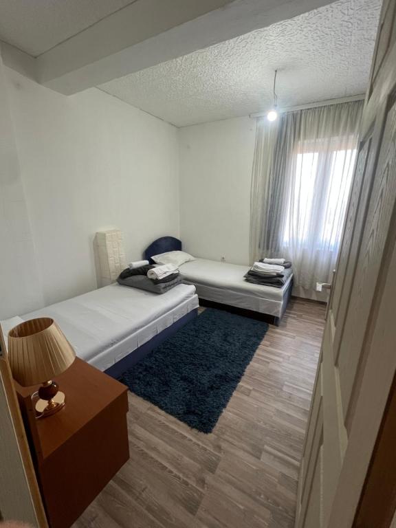 a room with a bed and a couch and a window at Milić apartmani 2 in Kuršumlija