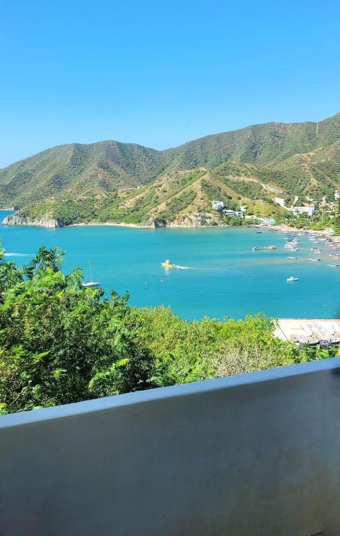 a view of a large body of water with mountains at Studio apartment in the mountains in Santa Marta