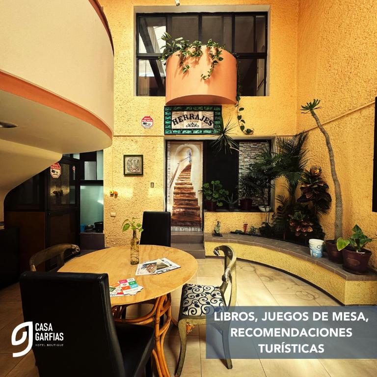 a restaurant with a table and chairs and a building at Talavera II in Querétaro