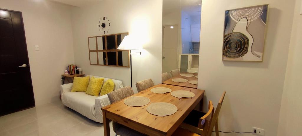a dining room with a table and a couch at Cebu Homestay Rental in Mandaue City