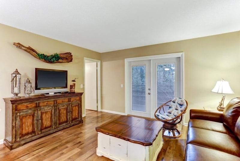 a living room with a flat screen tv and a couch at 8A Amelia Landings Condo in Fernandina Beach