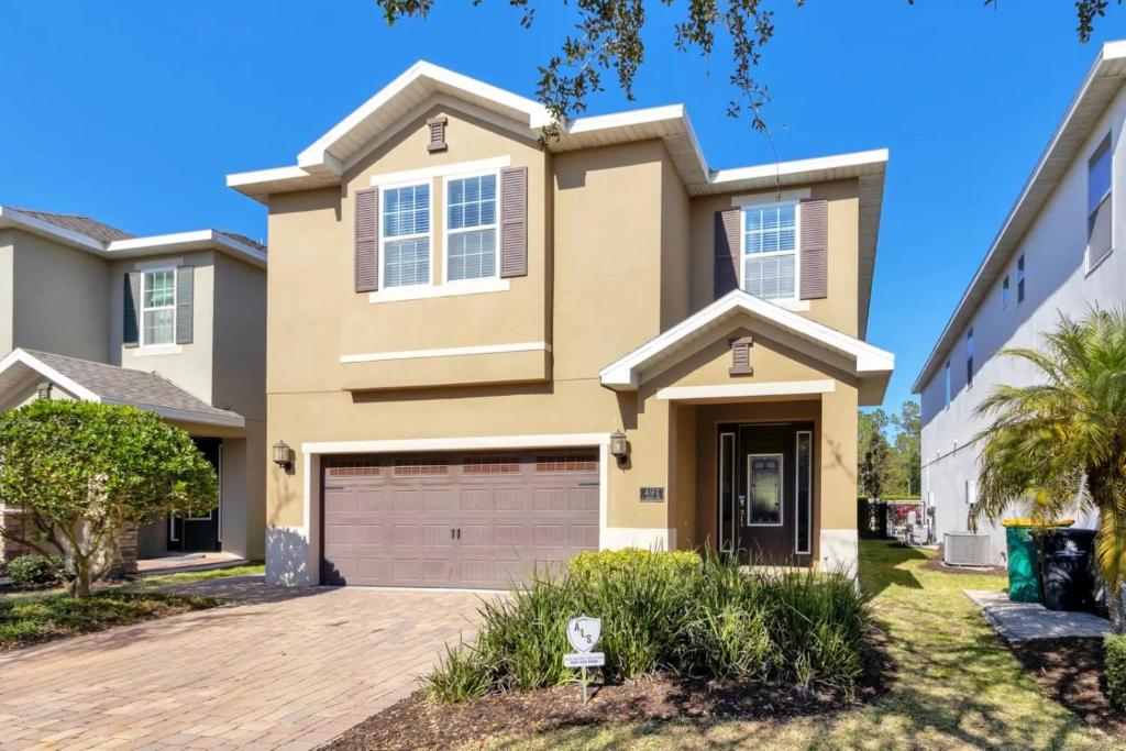 a house with a driveway in front of it at 491-8-LD-Private Pool with Game and Movie in Orlando