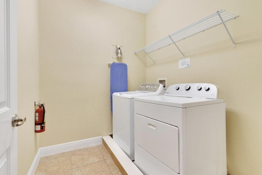 a laundry room with a washer and dryer at 491-8-LD-Private Pool with Game and Movie in Orlando