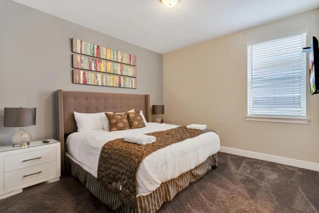 a bedroom with a bed and a book shelf at 491-8-LD-Private Pool with Game and Movie in Orlando