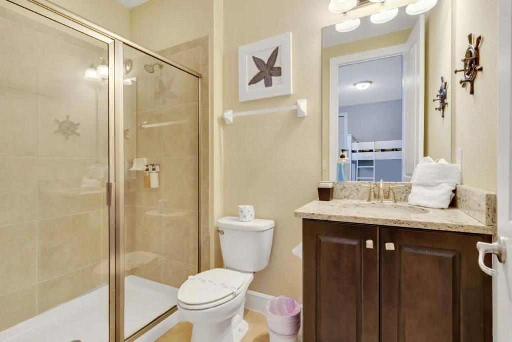 a bathroom with a shower and a toilet and a sink at 491-8-LD-Private Pool with Game and Movie in Orlando