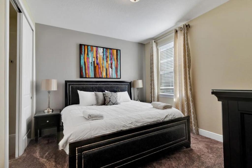 a bedroom with a large bed and a window at 491-8-LD-Private Pool with Game and Movie in Orlando