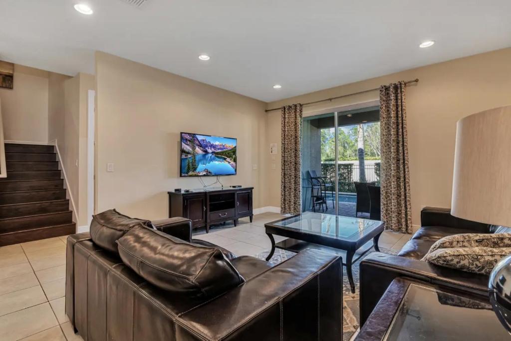 a living room with a couch and a table at 491-8-LD-Private Pool with Game and Movie in Orlando