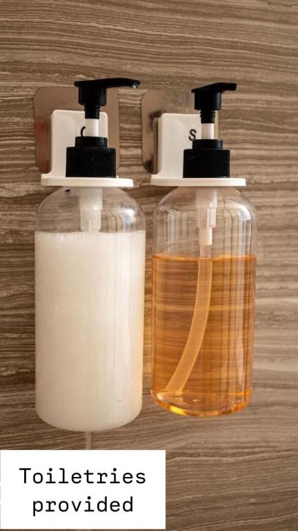 two bottles of soap sitting on top of a table at 491-8-LD-Private Pool with Game and Movie in Orlando