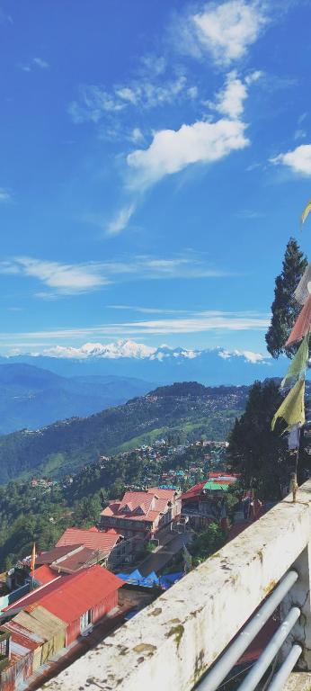 a view of a city with mountains in the distance at Viraj Kunj Homestay in Darjeeling