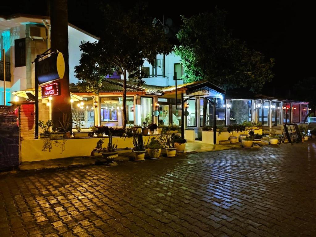 a cobblestone street with a restaurant at night at Han Dalyan Hotel in Dalyan
