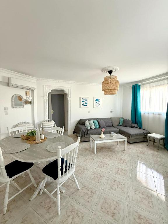 a living room with a table and a couch at Irenes Apartment in Larnaca