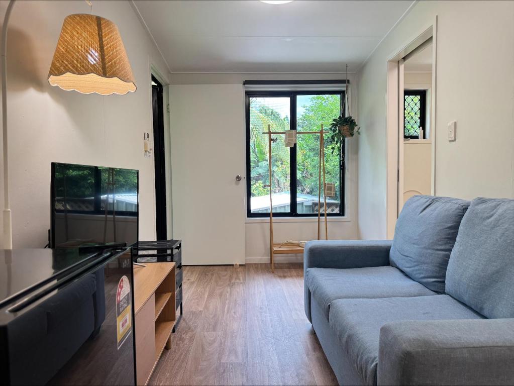a living room with a couch and a tv at Haven39 in Bayview Heights