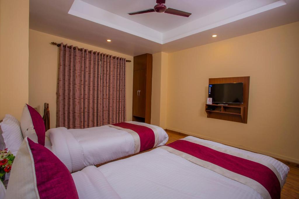 Postel nebo postele na pokoji v ubytování OYO 273 Hotel Rara Palace