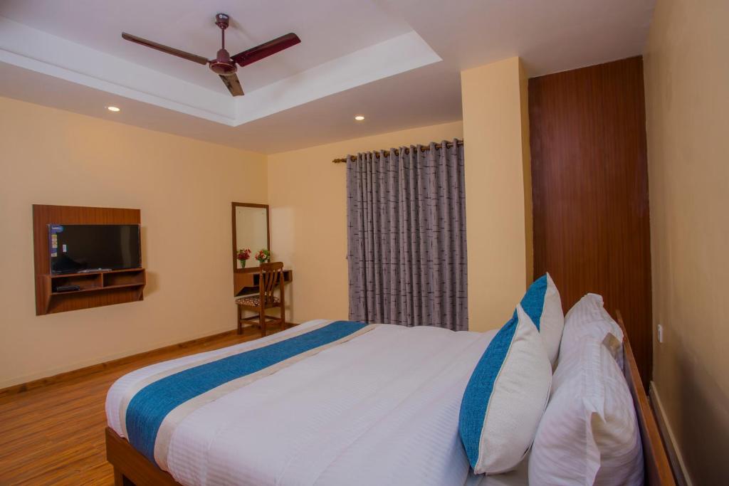 Postel nebo postele na pokoji v ubytování OYO 273 Hotel Rara Palace