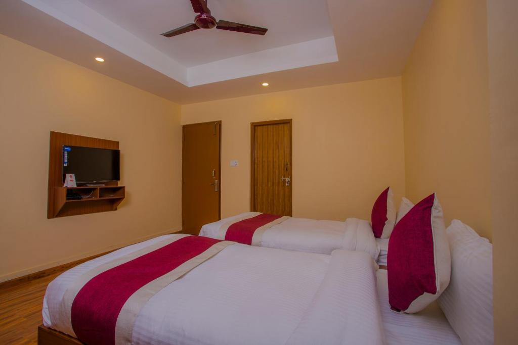 Postel nebo postele na pokoji v ubytování OYO 273 Hotel Rara Palace