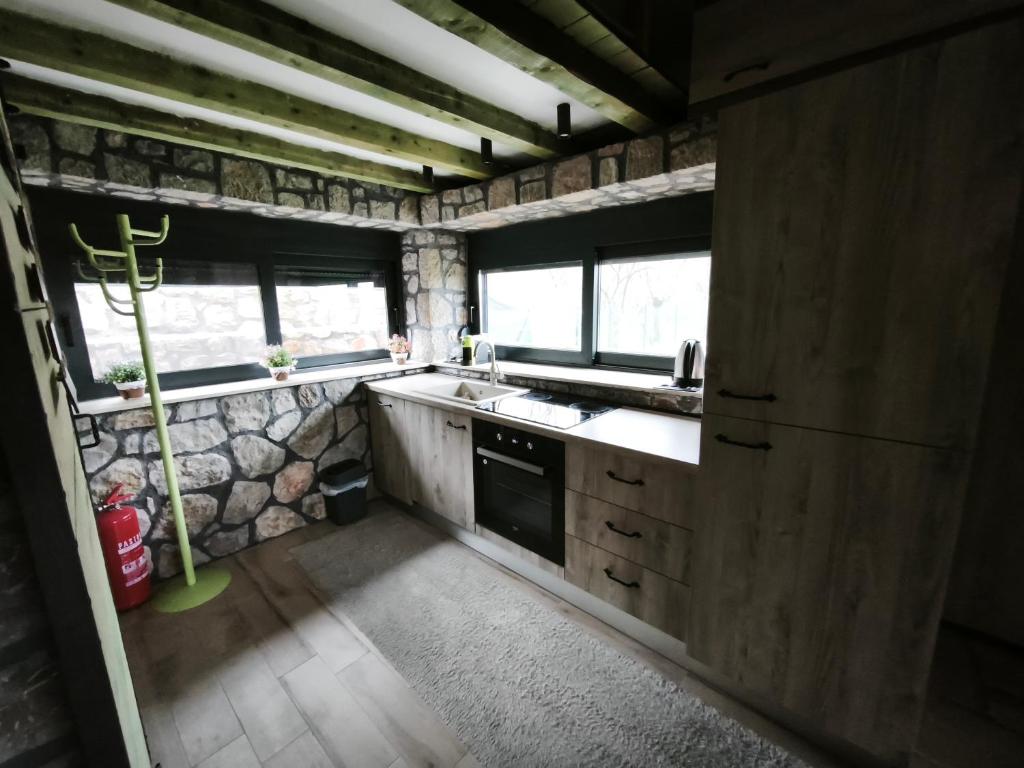 a kitchen with a sink and a stove at Stone House Montenegro in Danilovgrad