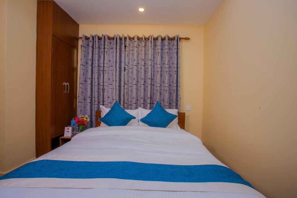 Postel nebo postele na pokoji v ubytování OYO 273 Hotel Rara Palace