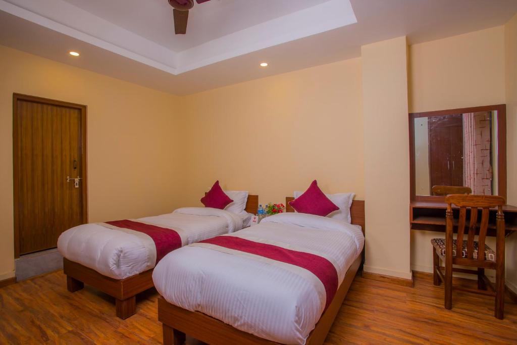 Postel nebo postele na pokoji v ubytování OYO 273 Hotel Rara Palace