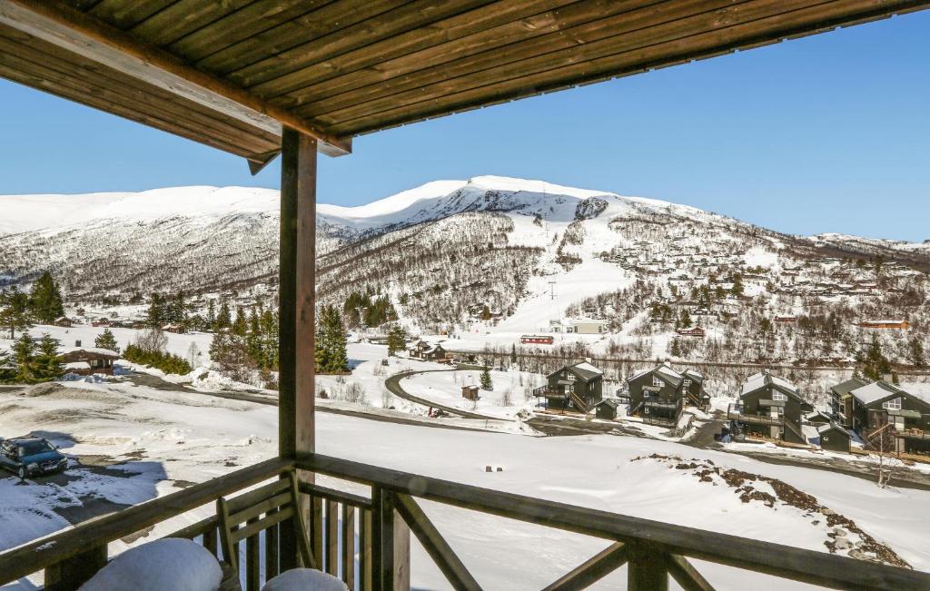 a view from the balcony of a ski resort with snow covered mountains at 2 Bedroom Cozy Apartment In Stranda in Stranda