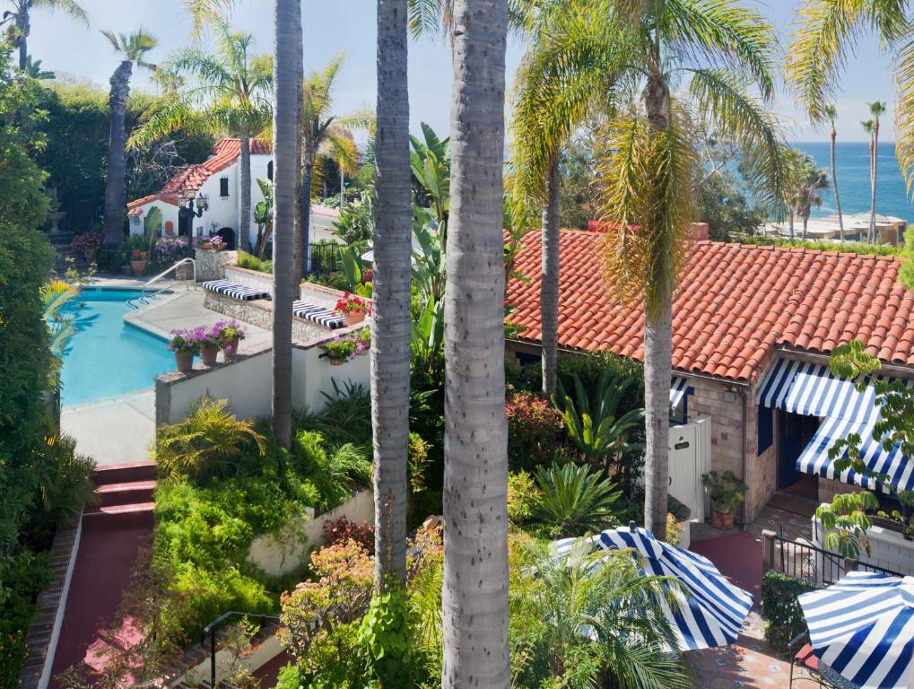 an aerial view of a house with a swimming pool and palm trees at Casa Laguna Hotel & Spa in Laguna Beach