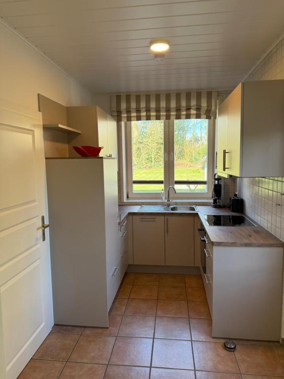 an empty kitchen with a sink and a window at Apartment 4 in Wyk auf Föhr