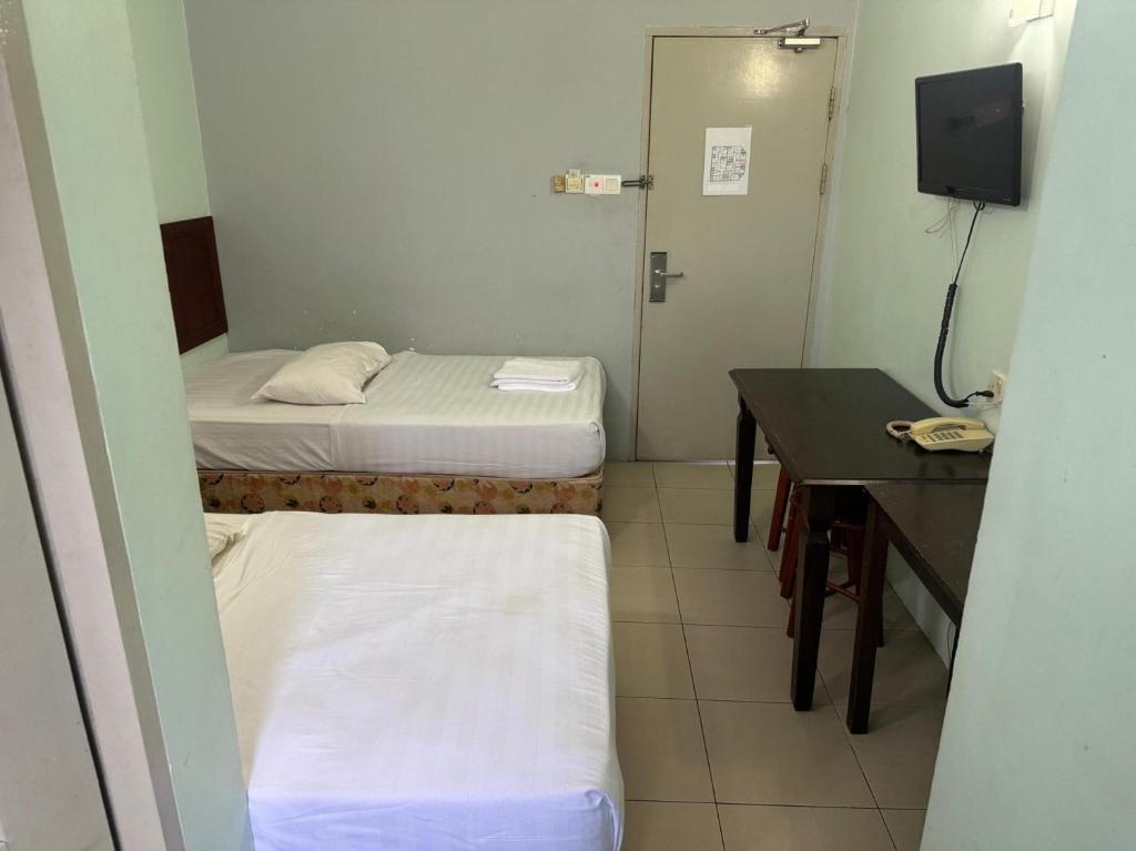 Postel nebo postele na pokoji v ubytování Hotel O Hotel Oriental