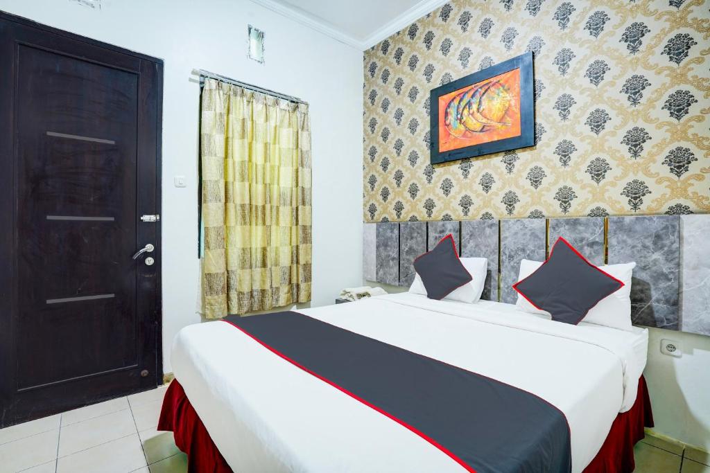 Postel nebo postele na pokoji v ubytování Hotel O Padang City Center Near Pantai Padang Formerly D'Dhave Hotel