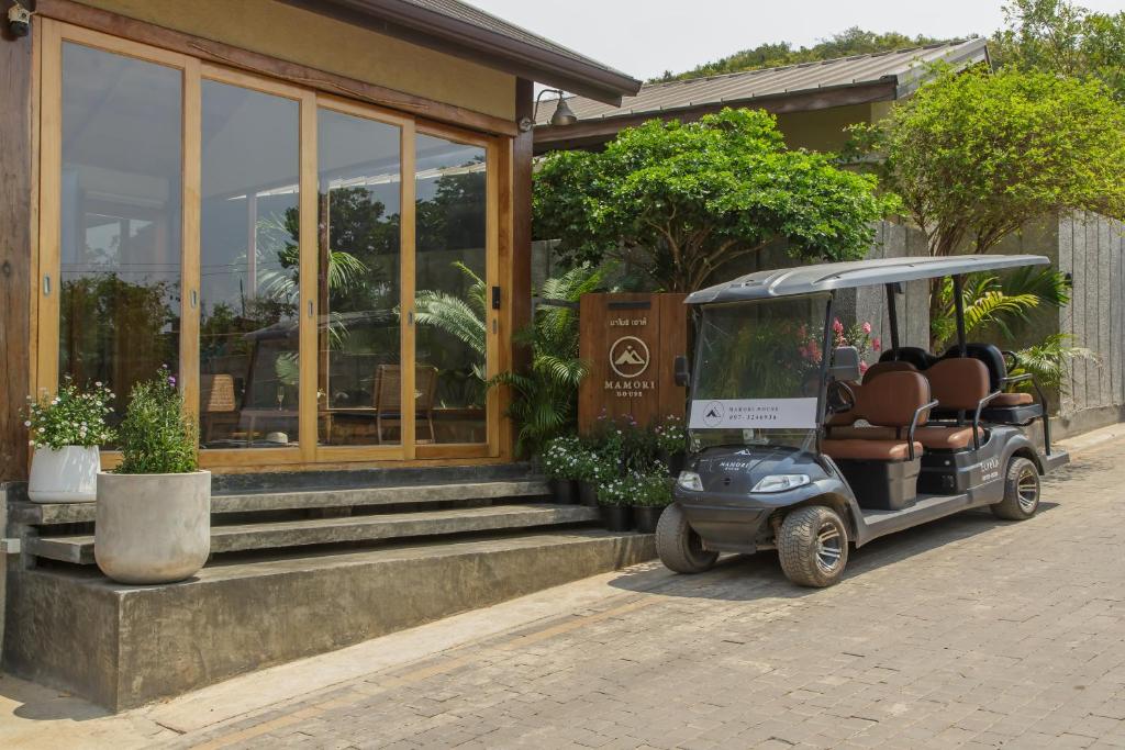 a golf cart parked in front of a building at Mamori House at Kohlarn in Ko Larn