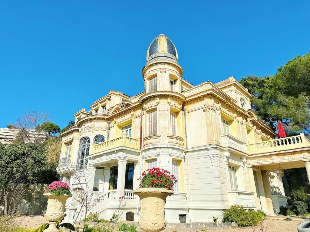 une vieille maison avec deux pots de fleurs devant elle dans l'établissement Villa Monique-Parking free, à Nice