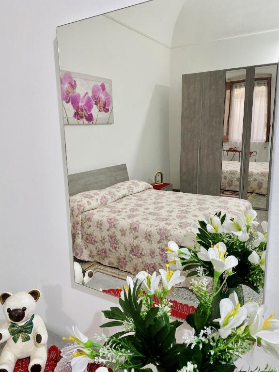 a bedroom with a bed and a mirror and flowers at Rio Mare in Termoli