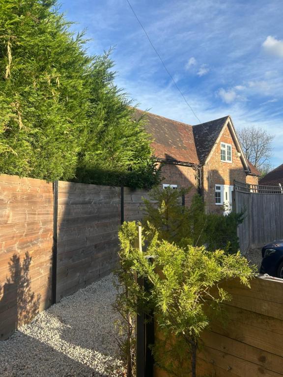 a backyard with a fence and a house at Holly Bank Cottage in Brenchley