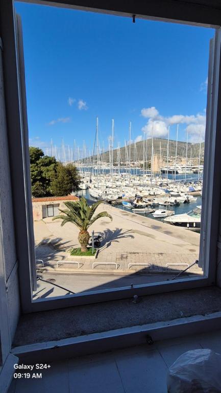 a window with a view of a marina with boats at YACHT marina Trogir, Heritage Bella Vistaa in Trogir