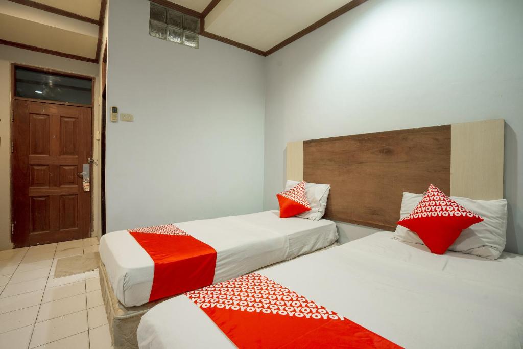 Postel nebo postele na pokoji v ubytování Super OYO 1088 Hotel Mega Sentosa