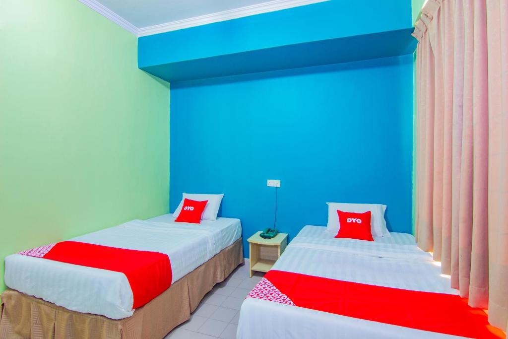 Postel nebo postele na pokoji v ubytování Super OYO 1159 Hotel New Sabah
