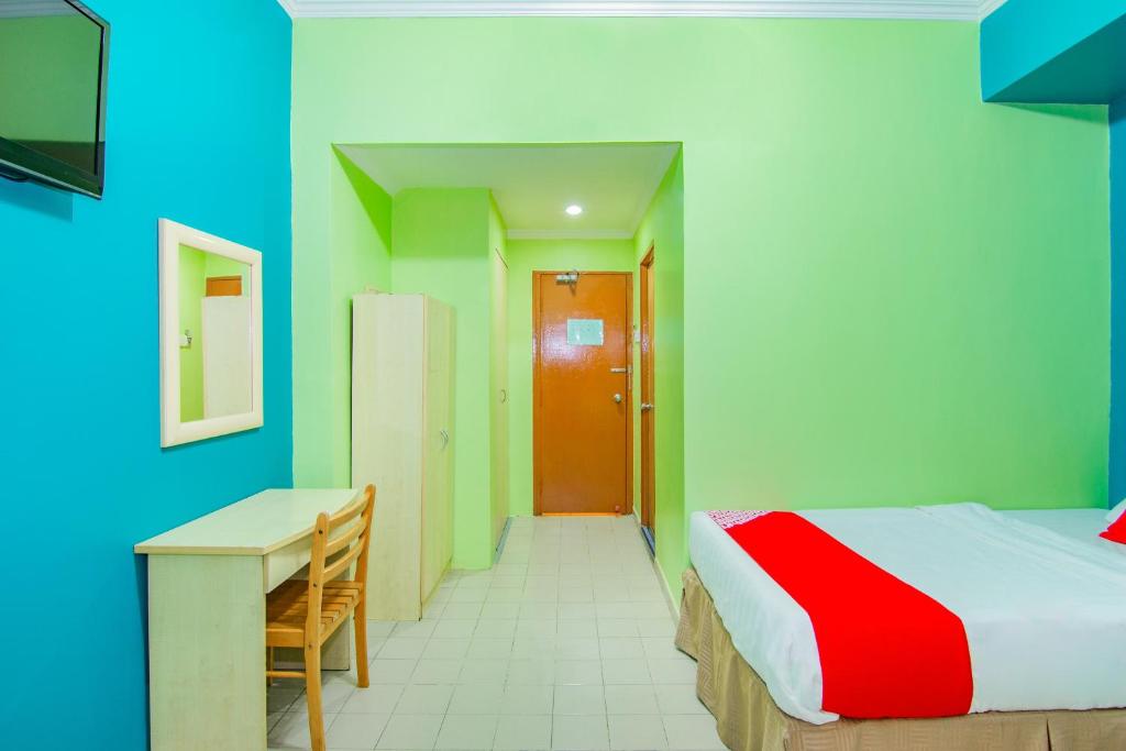 Postel nebo postele na pokoji v ubytování Super OYO 1159 Hotel New Sabah
