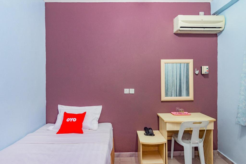 Postel nebo postele na pokoji v ubytování Super OYO 1159 Hotel New Sabah