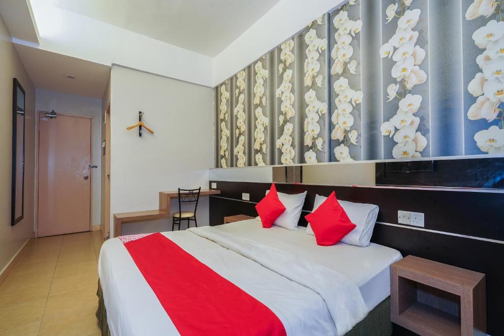 Postel nebo postele na pokoji v ubytování Hotel O Hotel Orchard Inn