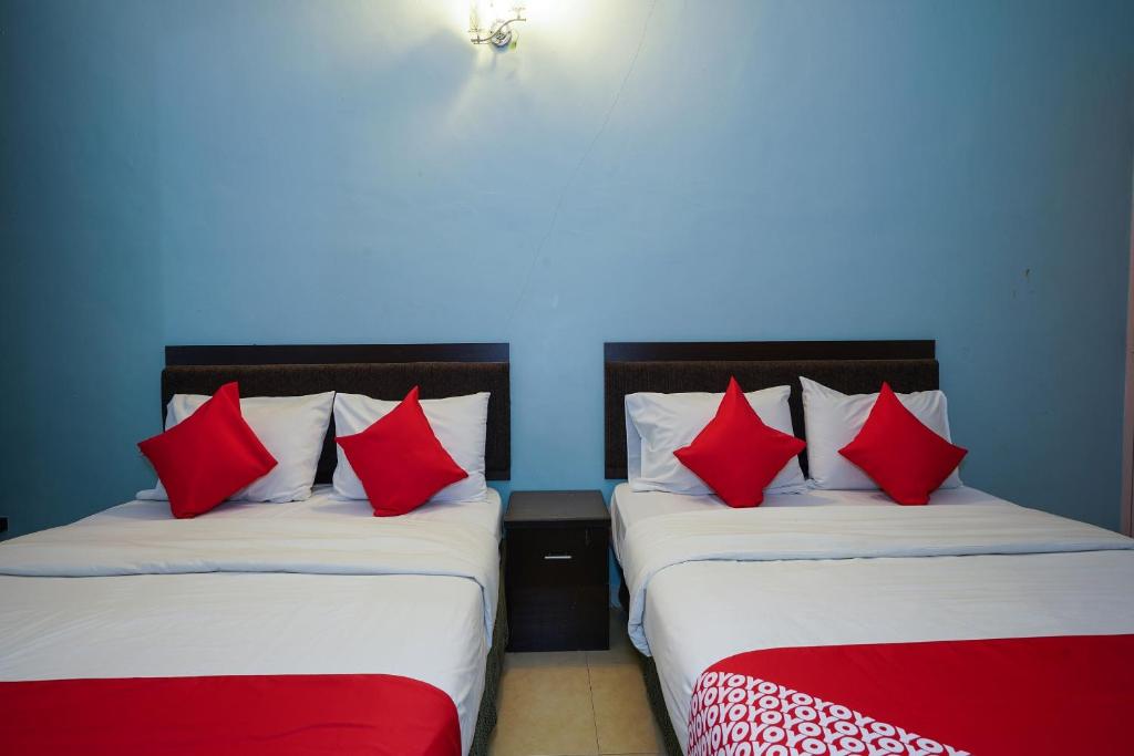 Postel nebo postele na pokoji v ubytování Hotel O Hotel Orchard Inn