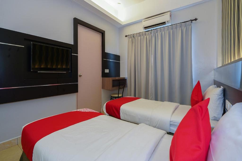 Postel nebo postele na pokoji v ubytování Hotel O Hotel Orchard Inn