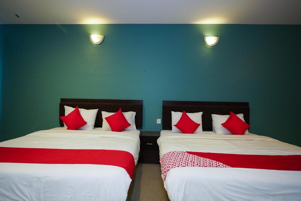 Postel nebo postele na pokoji v ubytování Hotel O Hotel Orchard Inn