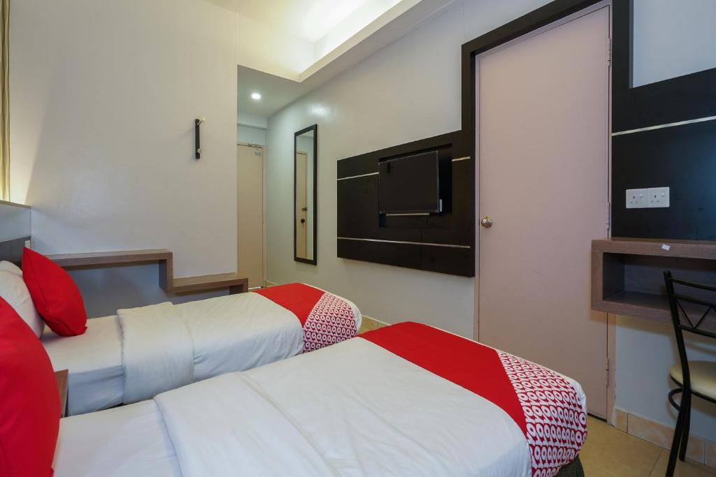 Postel nebo postele na pokoji v ubytování Hotel O Hotel Orchard Inn
